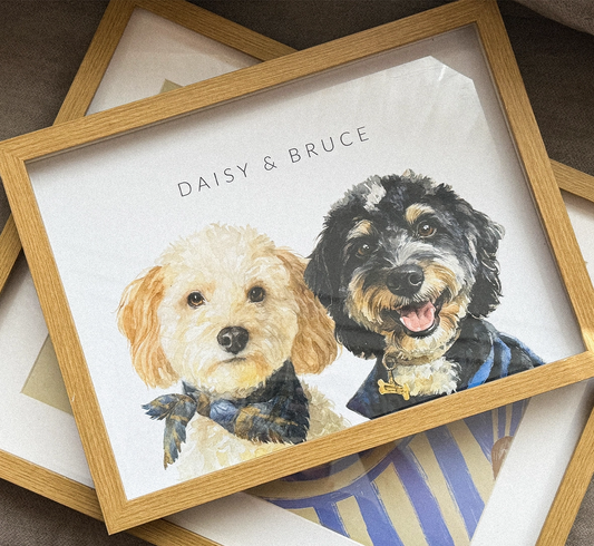 Framed watercolor artwork of two dogs with 'Daisy & Bruce' text on a striped surface.