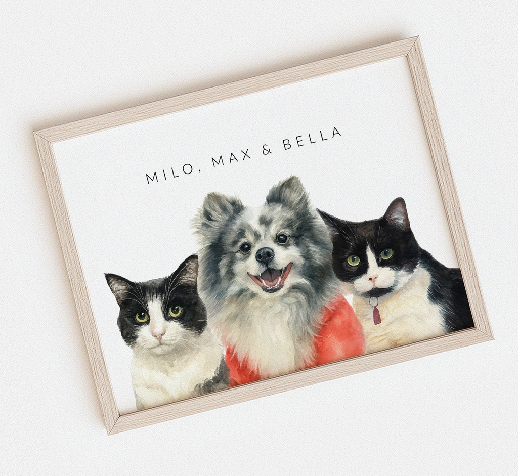 Framed watercolor artwork with three pets: two cats and a dog, on a white background.