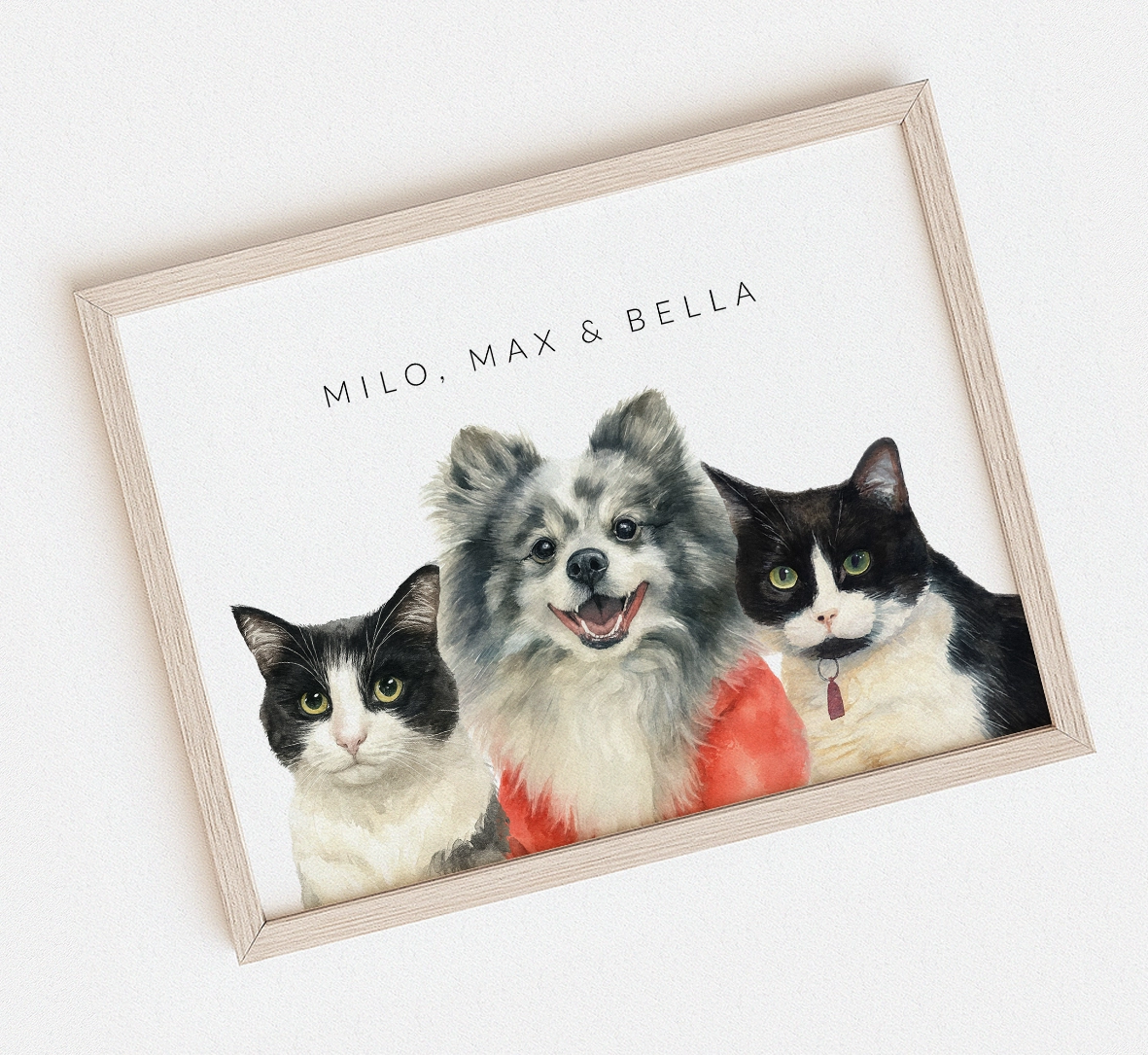 Framed watercolor artwork with three pets: two cats and a dog, on a white background.